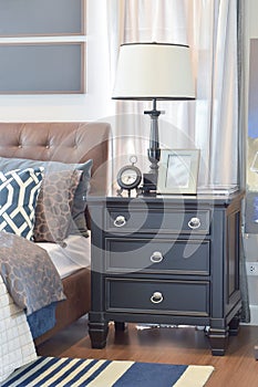 Cozy bedroom with pillows and reading lamp on bedside table