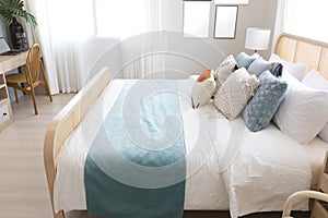 Cozy blue bedroom with modern interior, lamp over bedside table.