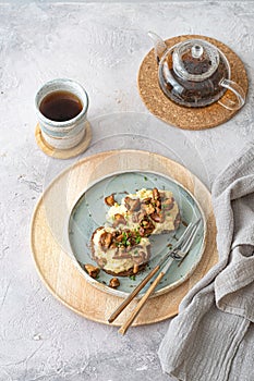 Cozy breakfast Scrambled eggs with chanterelle on buns with tea, copy space