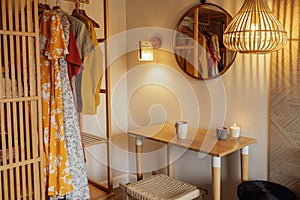 Cozy bright interior of a bedroom with a wooden wardrobe and clothes