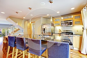 Cozy bright kitchen with granite counter top, kitchen island