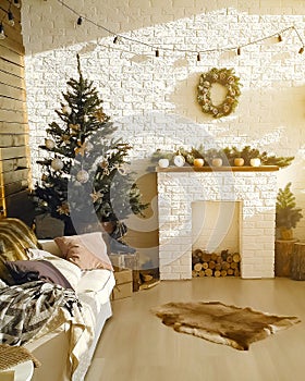 Cozy bright light modern interior of living room with comfortable couch, fireplace woods, christmas tree, new year
