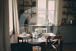 Cozy cabin interior. Country grey kitchen with open shelving in rustic style