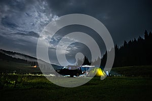 Cozy Camp Tourist In Mountains. Tent and overlanding 4x4 vehicle