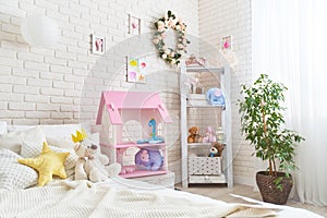 Cozy children room for little girl, with white wall with pictures, Dollhouse