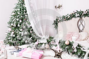 Cozy Christmas home interior. focus on the tree. New year decoration. bright bedroom room with large double bed.