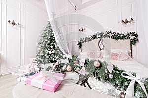 Cozy Christmas home interior. New year decoration. bright bedroom room with large double bed.
