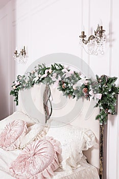 Cozy Christmas home interior. New year decoration. bright bedroom room with large double bed.