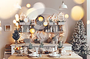 Cozy Christmas home. Kitchen interior with various holiday decorations and xmas tree