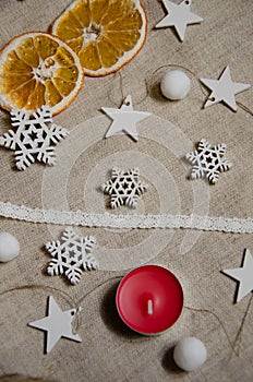 Cozy Christmas and New Year`s mood with copy space. Festive background with dried orange slices, candle, soft balls, decorative