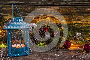 Cozy christmas still life with lamp and fir branches