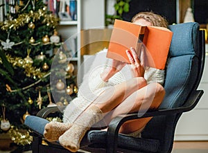 cozy Christmas time at home woman reading a book hygge