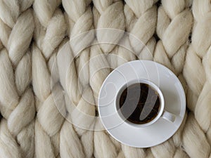 Cozy composition, closeup merino wool blanket, warm and comfortable atmosphere. Knit background