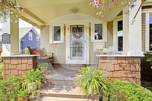 Cozy covered porch with white columns in American craftsman house