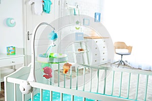 Cozy crib in light baby room