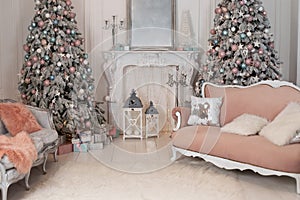 Cozy decorated room for Xmas. Decorated Christmas tree with gifts, fireplace and sofa. Christmas room interior home. Stylish inter