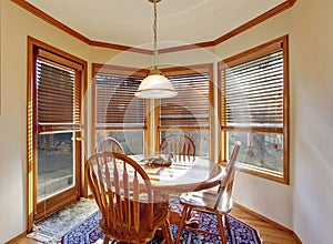 Cozy dining area with wooden table set and rug