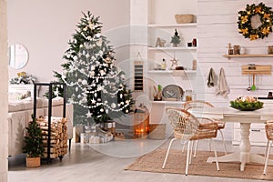 Cozy dining room interior with Christmas tree and festive decor