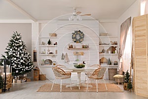 Cozy dining room interior with Christmas tree and festive decor