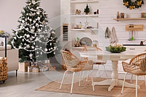 Cozy dining room interior with Christmas tree and festive decor