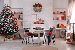 Cozy dining room interior with Christmas tree and festive decor