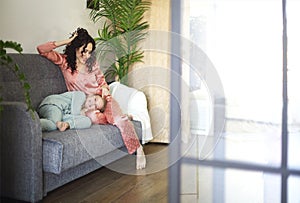 Cozy domestic photo of happy mother and daughter in pajamas spending lazy family weekend at home