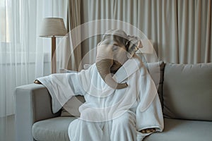 Cozy elephant wrapped in bathrobe relaxing at home - comfort concept.