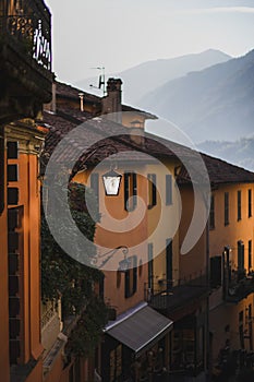 Cozy european old city evening view. Metal lantern, orange facades, tiled roof