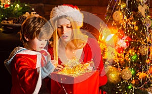 Cozy evening at home. Mom and kid play together christmas eve. Happy family. Mother and little child boy son friendly