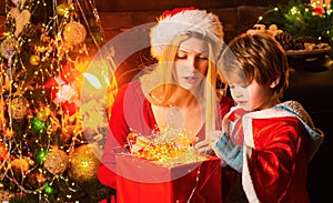 Cozy evening at home. Mom and kid play together christmas eve. Happy family. Mother and little child boy son friendly