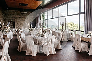 Cozy event space set with tables and chairs, ready for a wedding