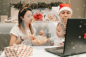 Cozy family christmas, watching video on laptop, happy fun and xmas holiday together at movie night or via video link