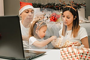 Cozy family christmas, watching video on laptop, happy fun and xmas holiday together at movie night or via video link
