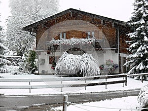 Cozy farmhouse in winter at snowfall