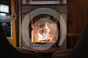 Cozy Fireplace Setting with Armchairs by Stone Mantel