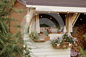 Cozy garden window with flowers and lights