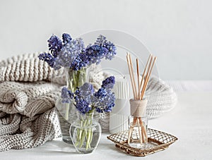 Cozy home composition with muscari flowers and aroma sticks