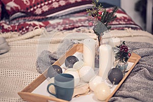Cozy home with cup of coffee and a book. Hygge style. Mug of black coffee wrapped in warm scarf on wooden board. Top