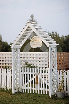 Cozy home garden with white fence and flowers.