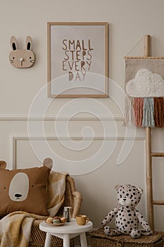 Cozy ids room interior with mock up poster frame, plush toys, brown pillow, braided armchair, round stool, ladder with ornament,