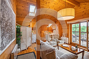 Cozy interior of a country house in a wooden design. Spacious living room on the second floor