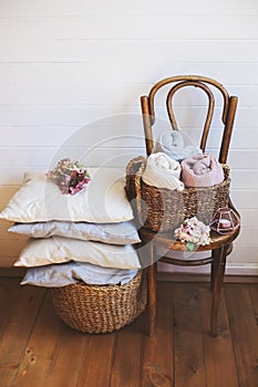cozy interior details, scandinavian mininalistic lifestyle. Organizing clothes in wicker backets
