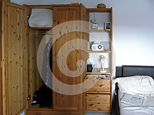 Cozy interior of a living room in an apartment or hotel with a wardrobe and a bed