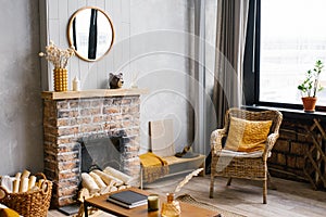 Cozy interior of the living room rattan chair and Fireplace. Rustic design of the House for a Warm Interior Space of an Alpine