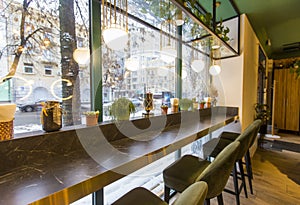 Cozy Interior of restaurant in morning lights with big window