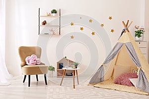 Cozy kids room interior with play tent