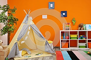 Cozy kids room interior with play tent