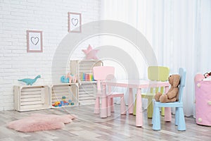 Cozy kids room interior with table, chairs