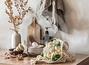 Cozy kitchen in a minimalist Scandinavian style still life. Decorative dried flowers in a ceramic vase, eggs in a bowl,