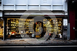 Cozy Liquor Store Display in Dinant, Belgium at Twilight